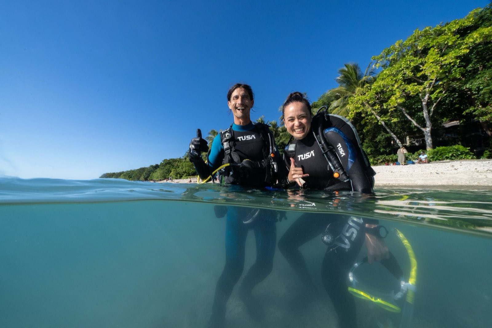 Two divers at the surface giving the OK signal.